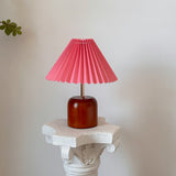 Cylvara wood table lamp displayed with a vivid pink pleated shade