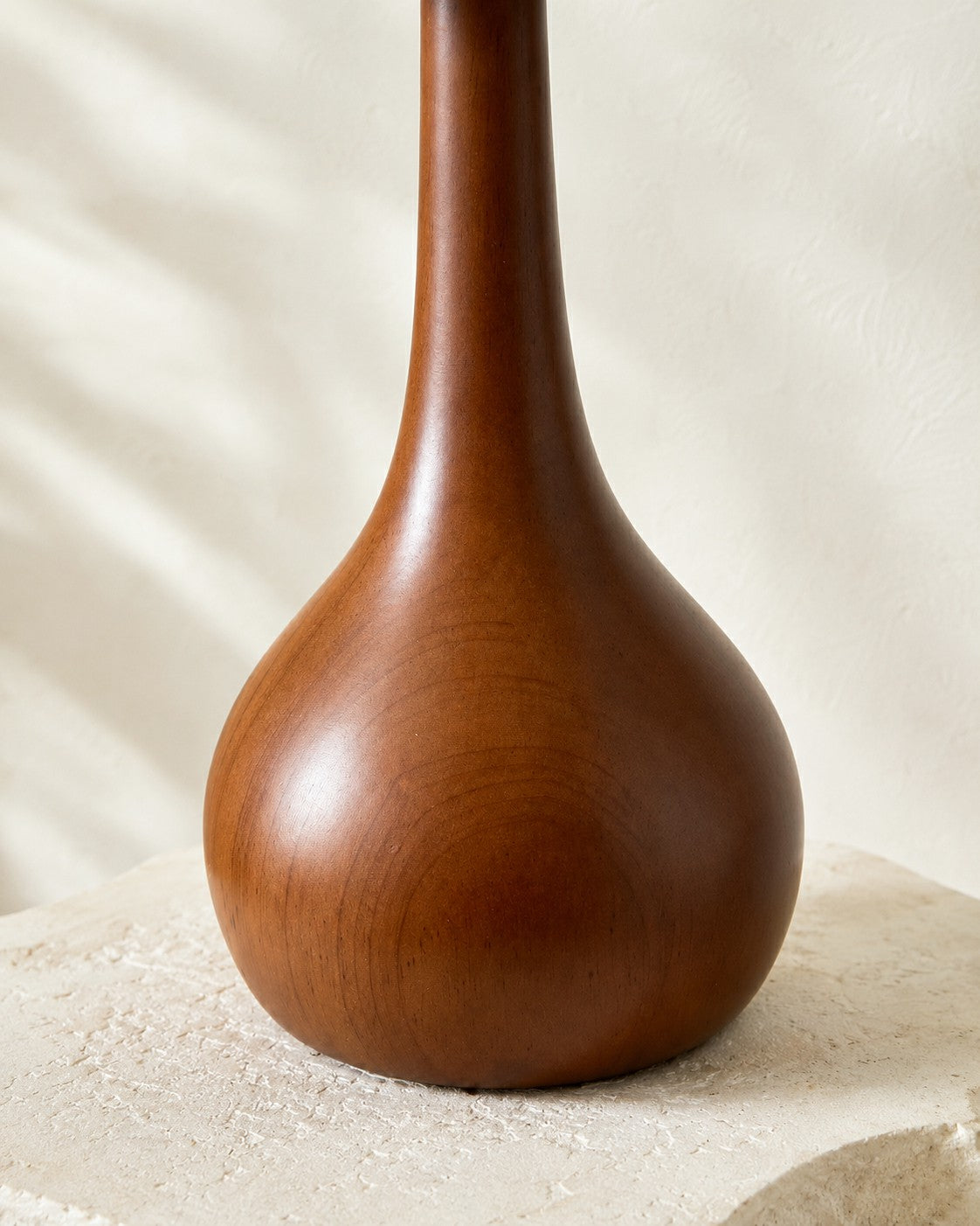 Close view of the walnut-tone wooden lamp base